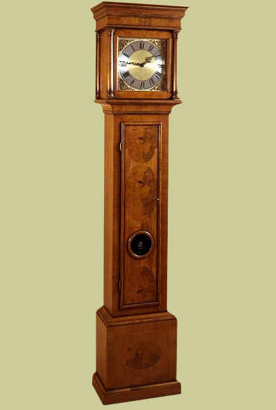 Period style walnut veneered longcase clock with bullseye glass panel.