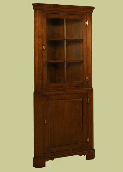 Corner cupboard, with astragal glazed upper section, for display, and lower section serving as corner cupboard storage.