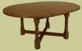Extendable round dining table, with one leaf inserted.