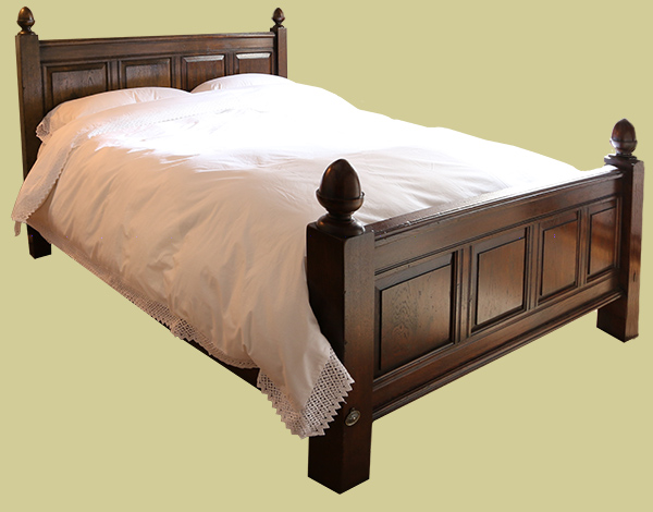 Oak bed with fielded panels and hand turned acorn finials