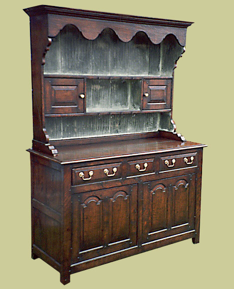 Welsh dresser with enclosed base. Handmade in solid oak, with period style features.