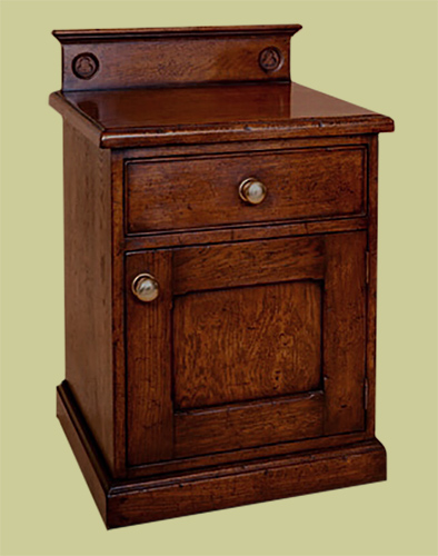Oak bedside cabinet, of enclosed form, with hand carved patera design to the up-stand.