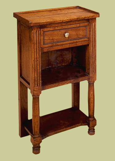 Oak bedside cabinet with open storage and one drawer. Other features include a potboard and decorative fluted framework, on this English handmade example.