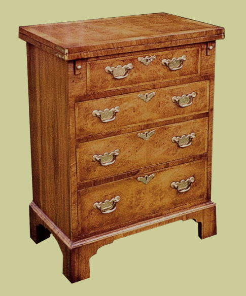 Bachelor chest in walnut veneer. The top folds over to make a small writing desk or level platform for a laptop etc., at normal working table height.