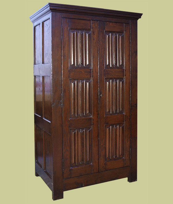 Oak wardrobe, with hand carved 16th century style linenfold panelled doors - front and side.