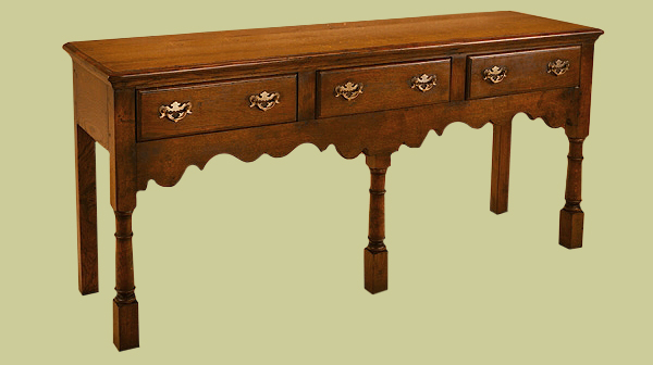 Solid oak 3 drawer low dresser with open base. A simple 18th century design with plain edge moulded drawers.