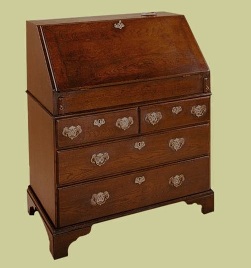 Traditional style oak bureau, shown closed, with four drawers and a well under the writing flap.