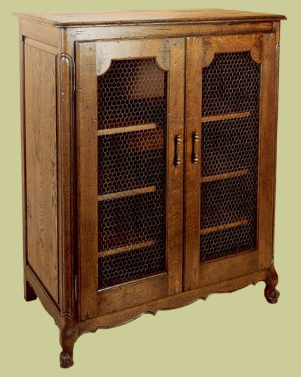 French style oak cabinet with mesh panels to the two doors.