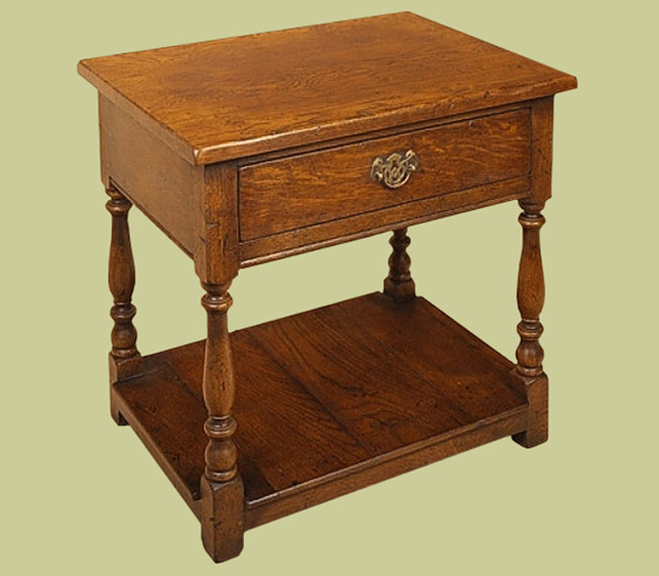 Oak lamp table with single drawer and useful pot board.