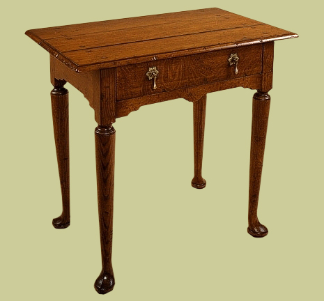 Oak side table, Georgian style, with carved pad feet.