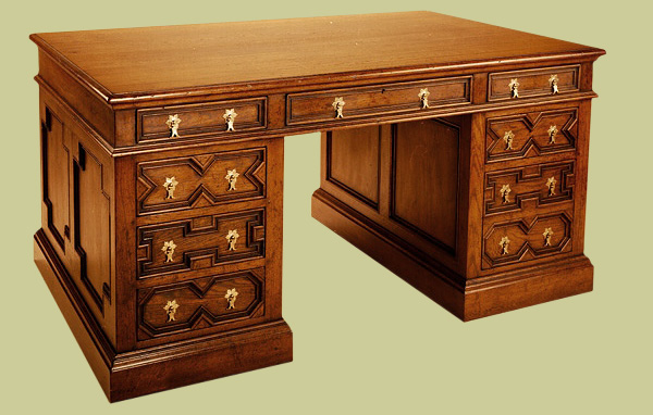 Oak pedestal desk, handmade in Britain, with 17th century style geometric mouldings.