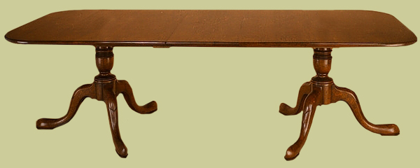 Extending twin pedestal dining table with cabriole legs.