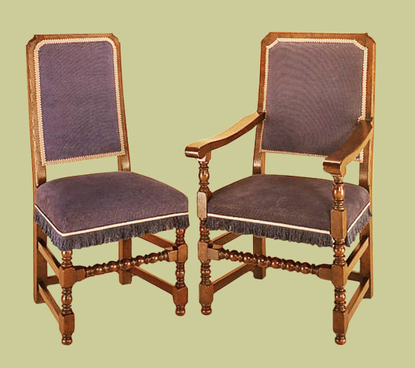 Joined oak dining chairs with upholstered back panel and seat.