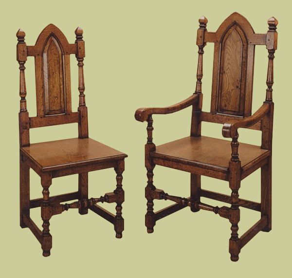 Joined Gothic style oak solid seat side chairs and armchairs.