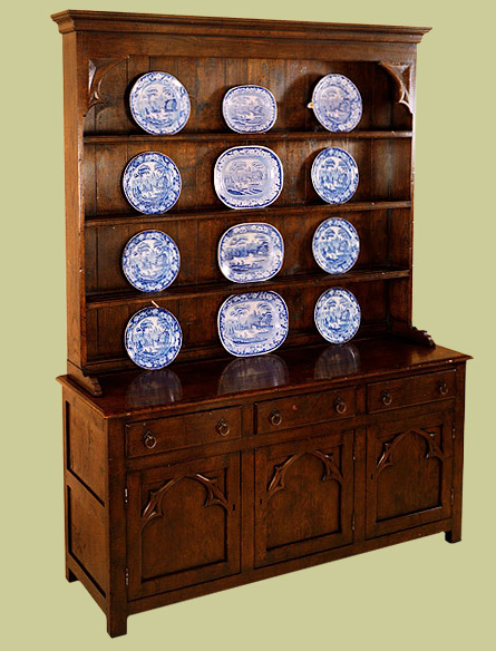 High dresser with attractive Gothic style doors and rack brackets.