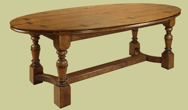 Refectory table with oval burr elm top, handmade with exposed feature dovetails.