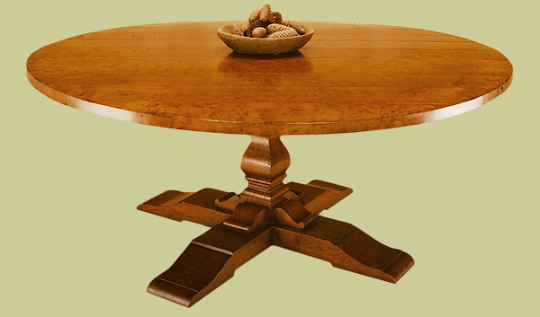 Round dining table with elm top on a cruciform base.