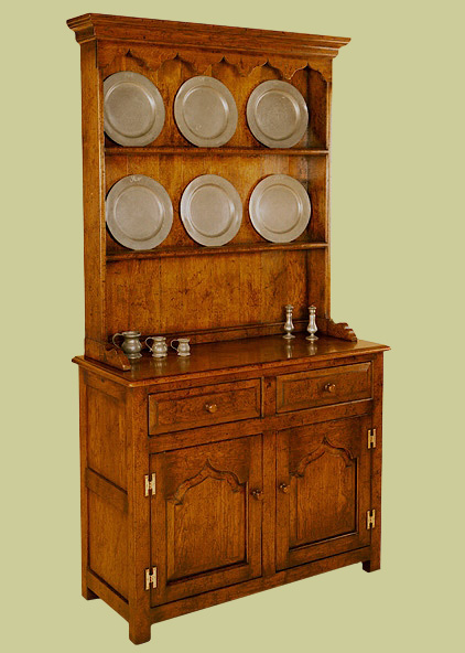 Small oak dresser, with plain plate rack, ogee shaped cupboard doors and 2 fielded front drawers.
