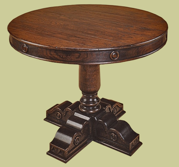 Drum table on single pedestal support with hand carved cruciform feet.