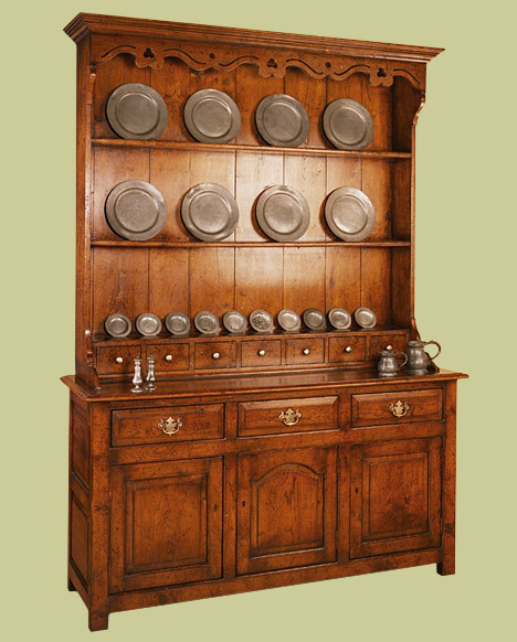 High dresser with a row of spice drawers in the plate rack and featuring an attractive shaped and pierced pelmet.