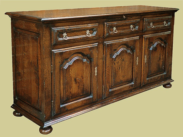 Oak cabinet dresser, with French Provincial influence, including overlaid doors and drawers.