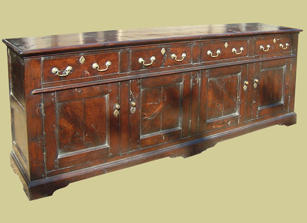 Four drawer antique style oak dresser base.