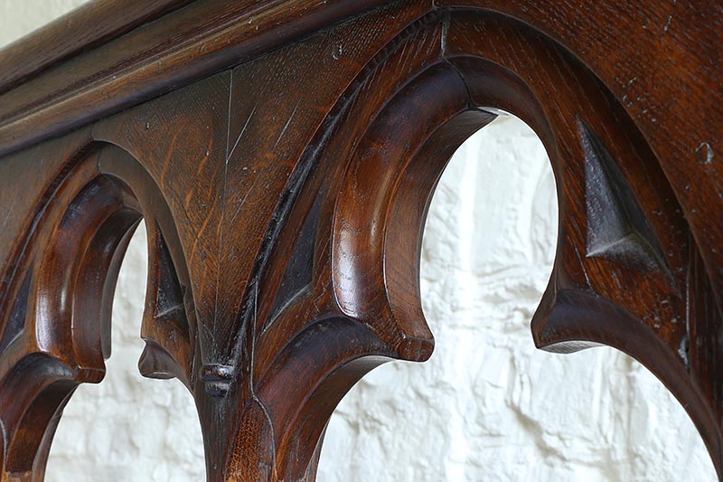 Trefoil head detail of open tracery headboard on Gothic style oak bed