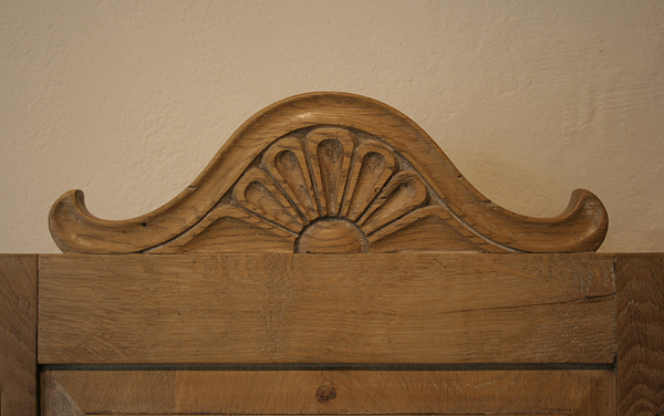 Carved cresting rail on oak dining chair