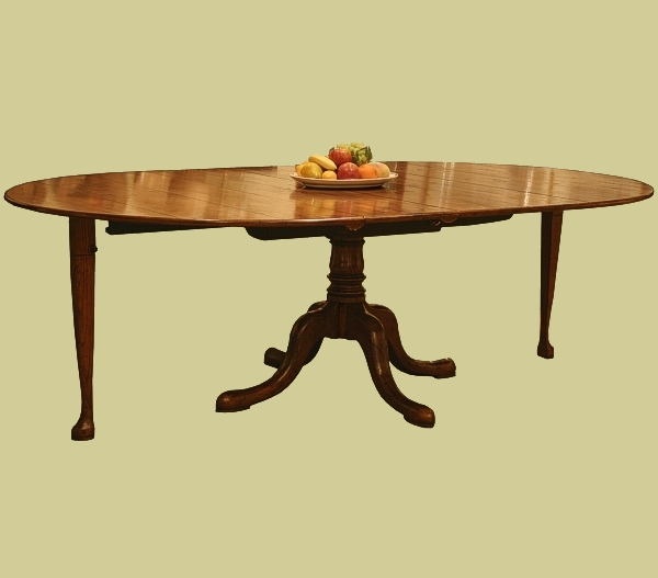 Extended round oak pedestal table