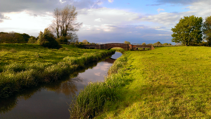 A distant view of Long Bridge from the banks of the Cuckmere