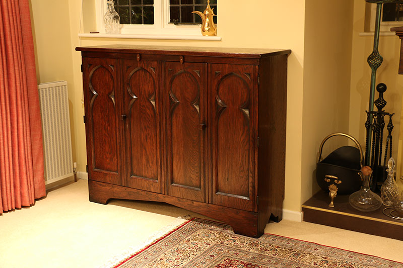 TV cabinet with medieval style tracery carved bi-fold doors