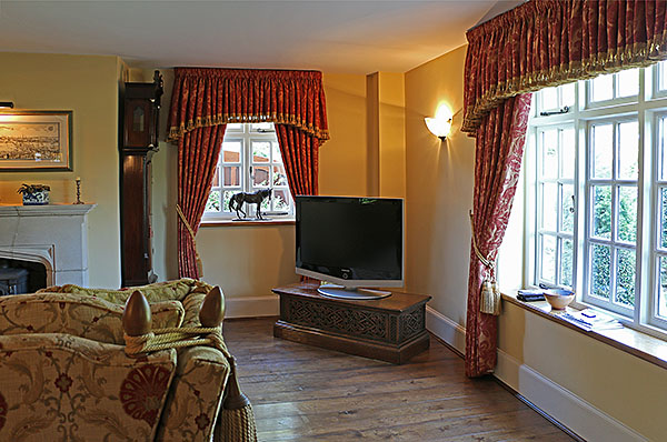 Elizabethan style carved oak TV base in country home