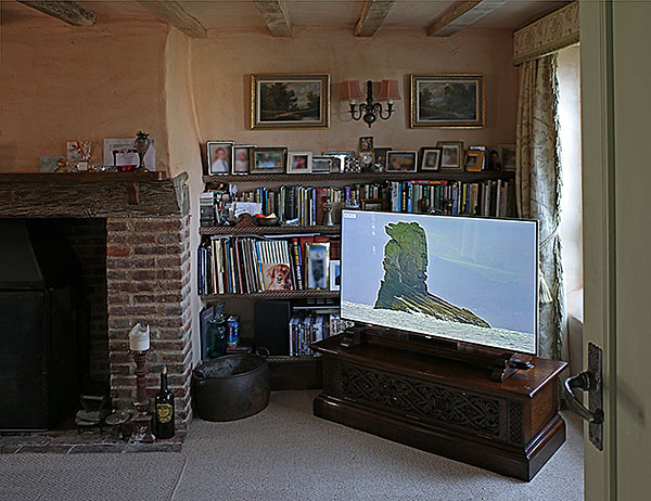Oak Elizabethan style TV stand, with TV mount, in an oak beamed sitting room