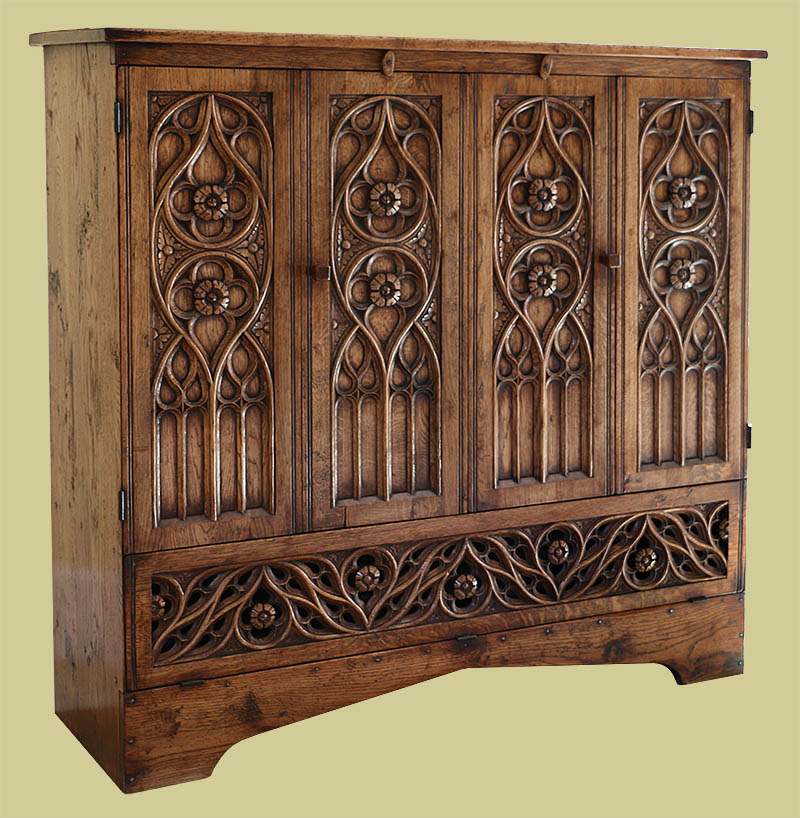 Hand carved oak tracery TV cabinet, in the Flamboyant period style