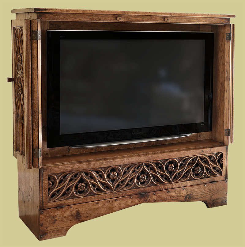 Hand carved oak tracery TV cabinet, shown in viewing mode, with bi-fold doors open