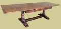 Heavy oak drawerleaf pedestal dining table, in period style, shown here in extended format.