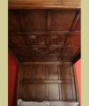 Oak panelled tester ceiling of 16th century Tudor style true 4-poster bed.