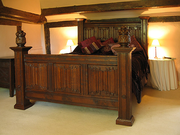 Linenfold carved oak bed in Kentish timber framed house.