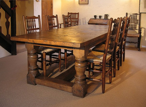Heavy oak table with spindle back chairs in dining room of clients Cheshire cottage.