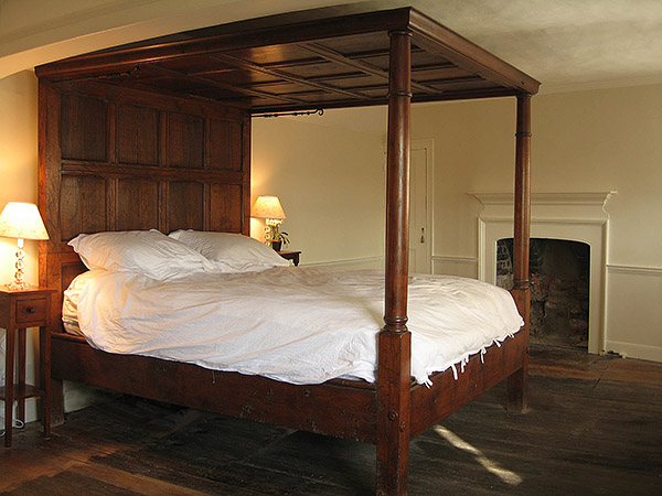 17th century style oak tester bed, with plain panels and doric column footposts, pictured in the bedroom of our clients Tudor and Georgian town house.