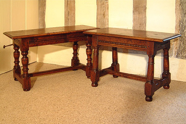 Small 17th century period style oak benches, in timber framed room.