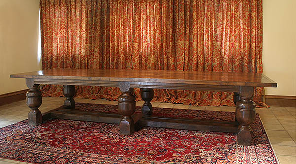 Bulbous 6 leg oak dining table in converted Suffolk barn.