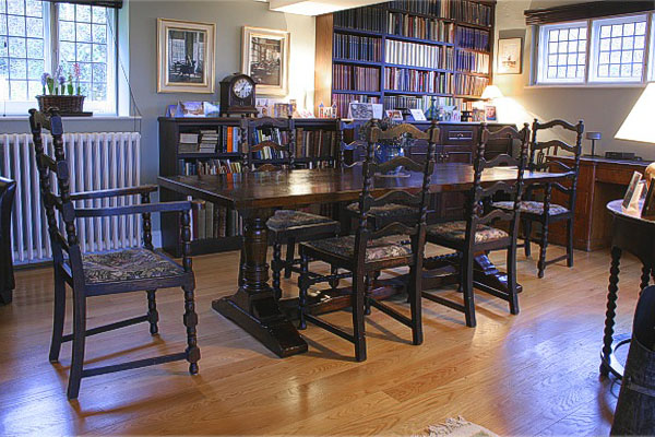 Oak pedestal table in character dining room of Sussex country cottage.
