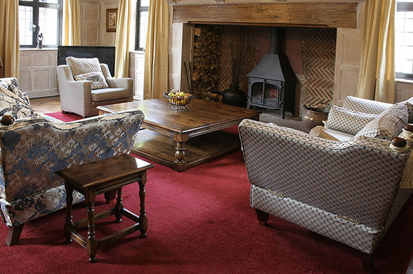 Large square oak coffee table and 17th century style joined stool, in sitting room of beautiful 1930