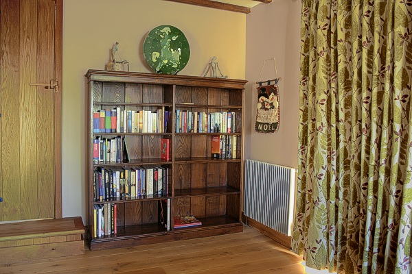 Bespoke double width oak bookshelves, in our clients Sussex country house.