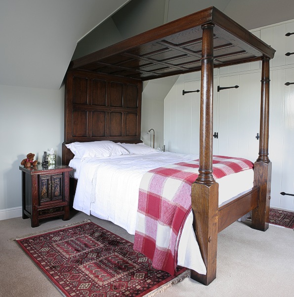 Specially commissioned oak four poster panelled bed, in Surrey cottage.