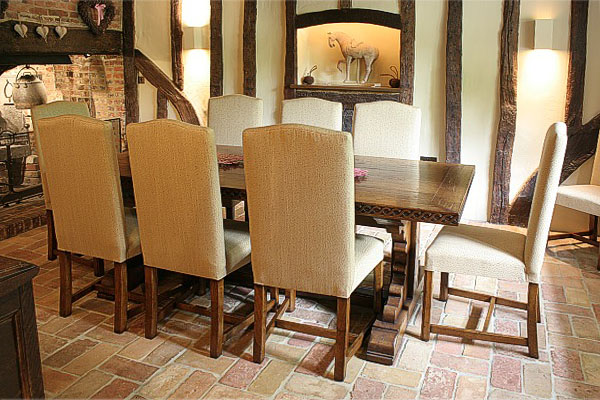 Fully upholstered oak dining chairs in timber framed house.