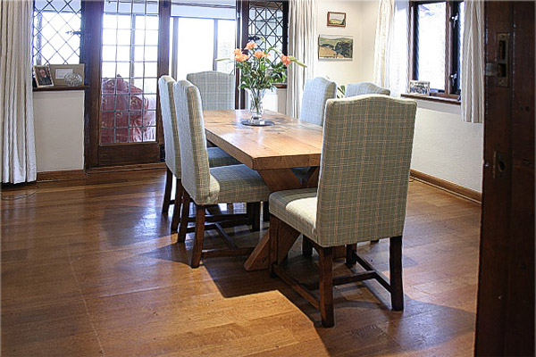 Oak fully upholstered dining chairs in early 20th century built traditional Sussex style house.