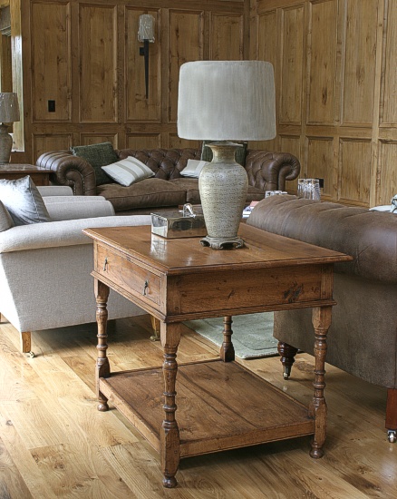 Oak lamp table, specially adapted to conceal the electrical wiring, in an oak panelled barn style sitting room.