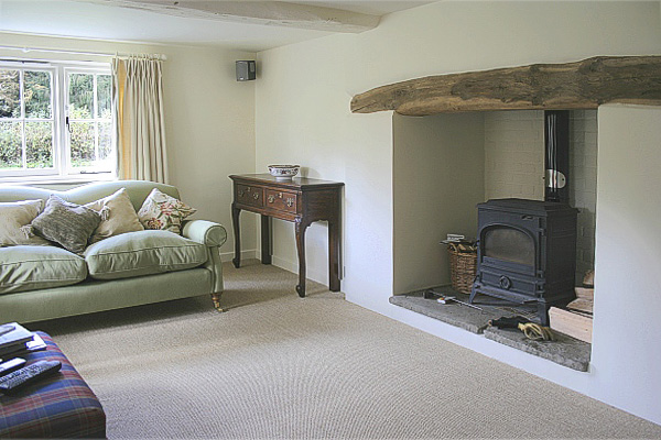 18th century style cabriole leg dresser base, in sitting room of Sussex country cottage.